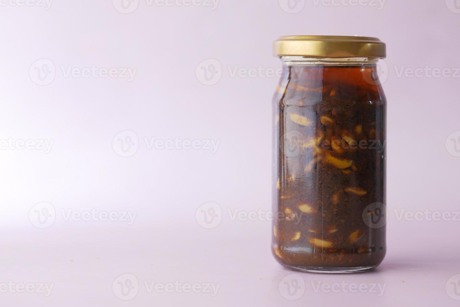 Homemade Garlic Pickle in a glass jar on table , photo