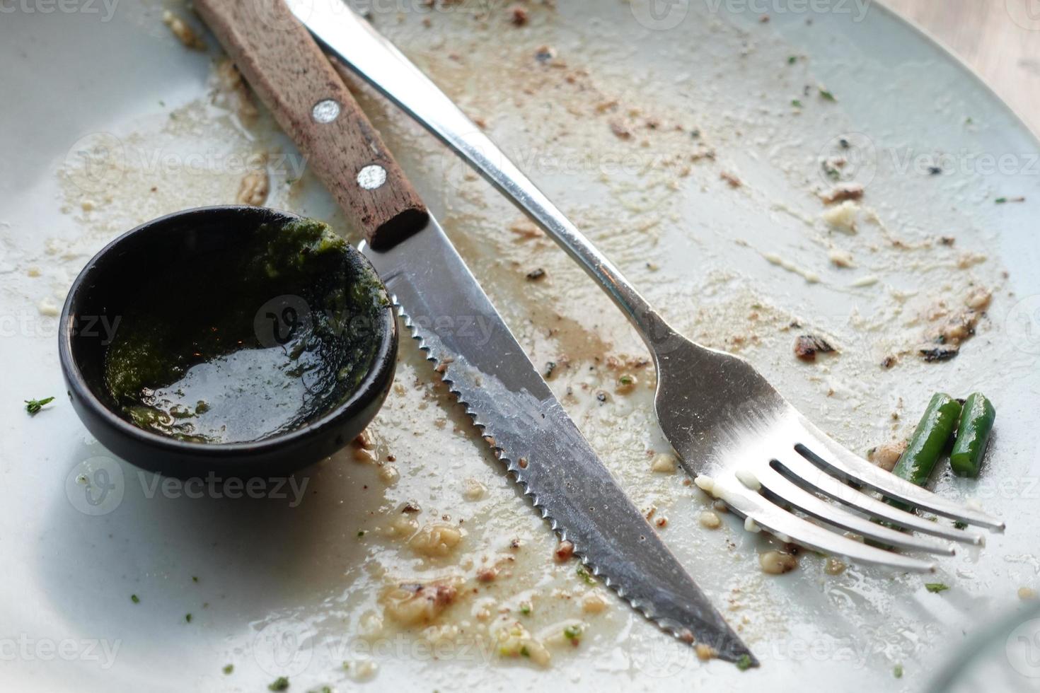 Empty plate after eating on table photo