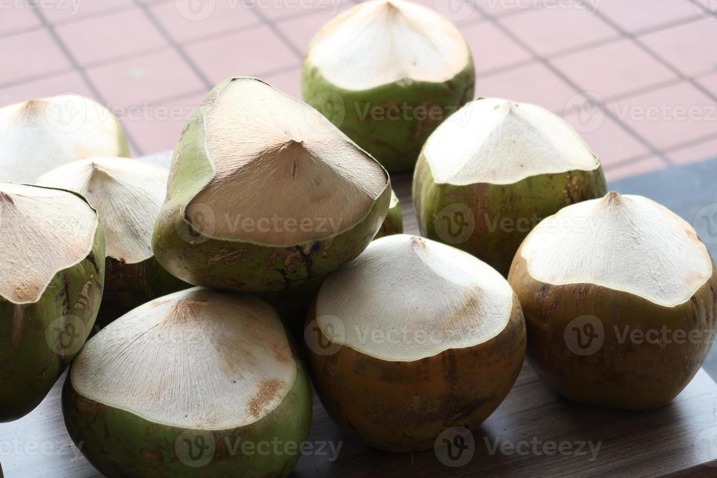 stack of fresh coconut display for sale photo