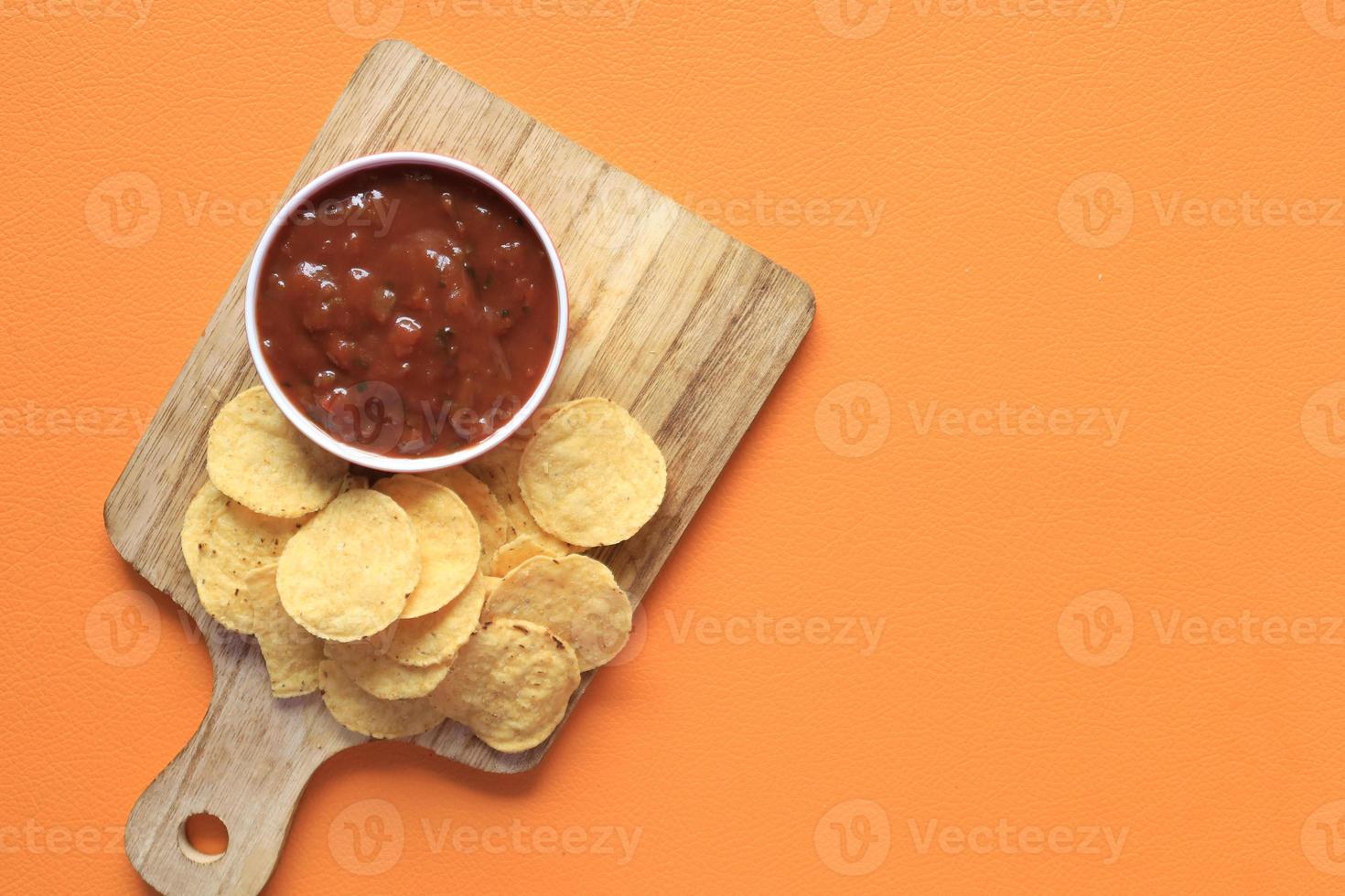 top view of chips and salsa on table , photo