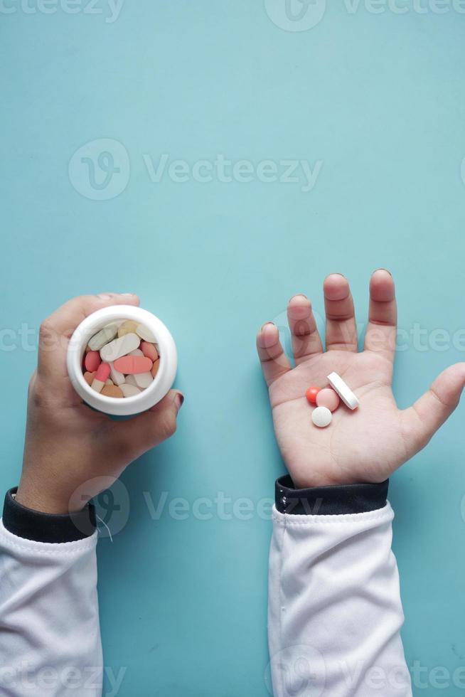 close up of medical pills on palm of child hand photo