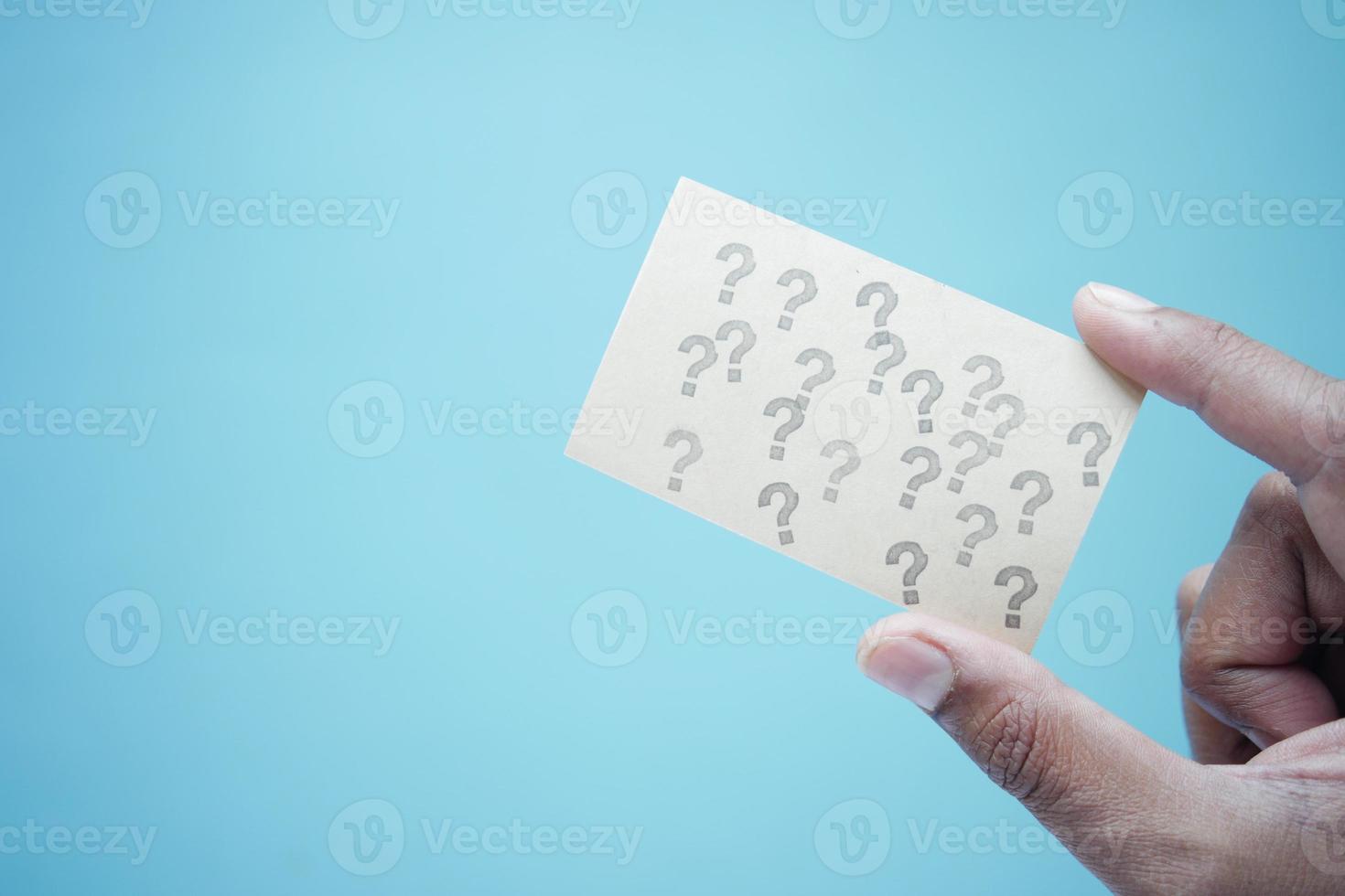 holding a paper with question mark photo