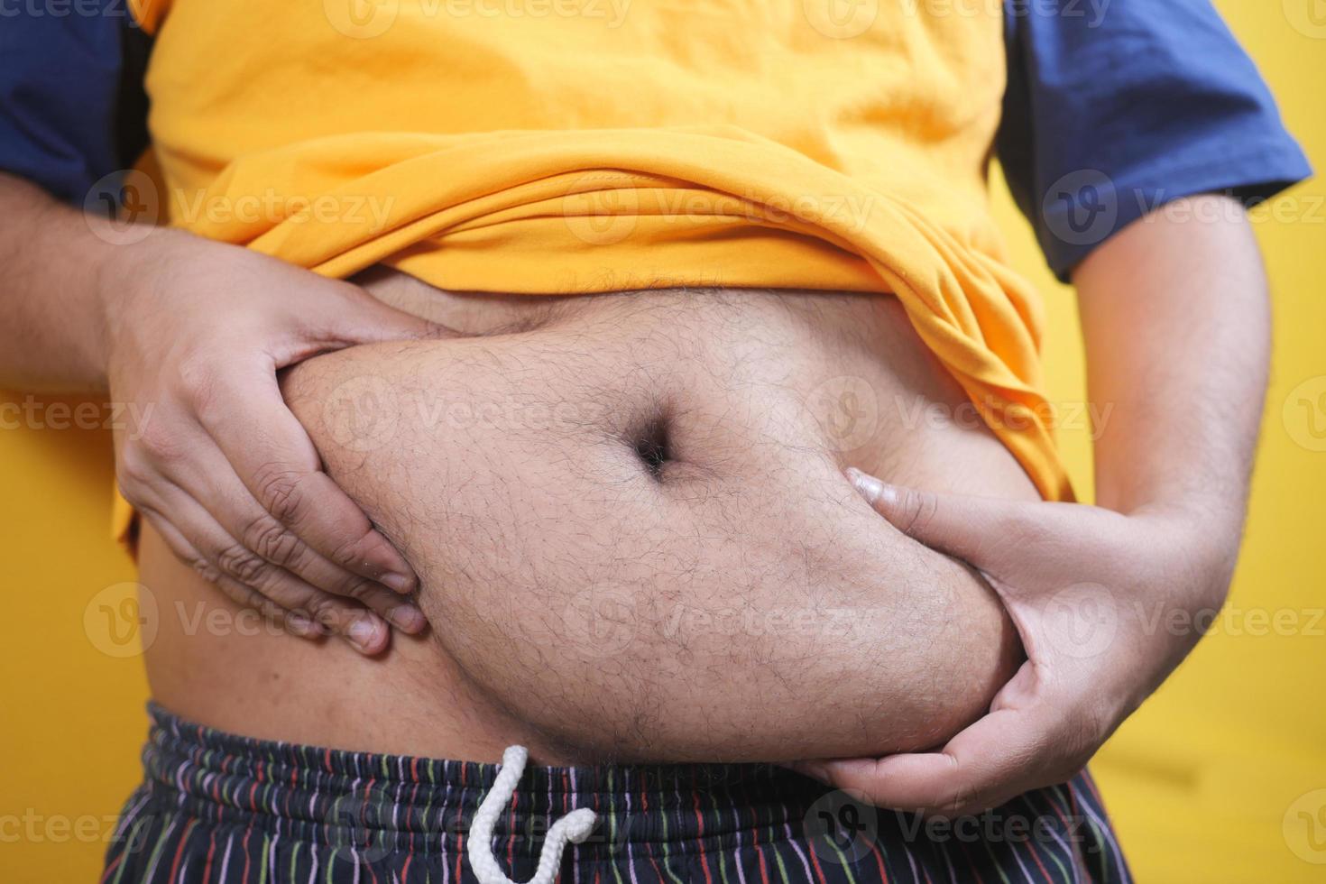 young men holding his belly fat photo