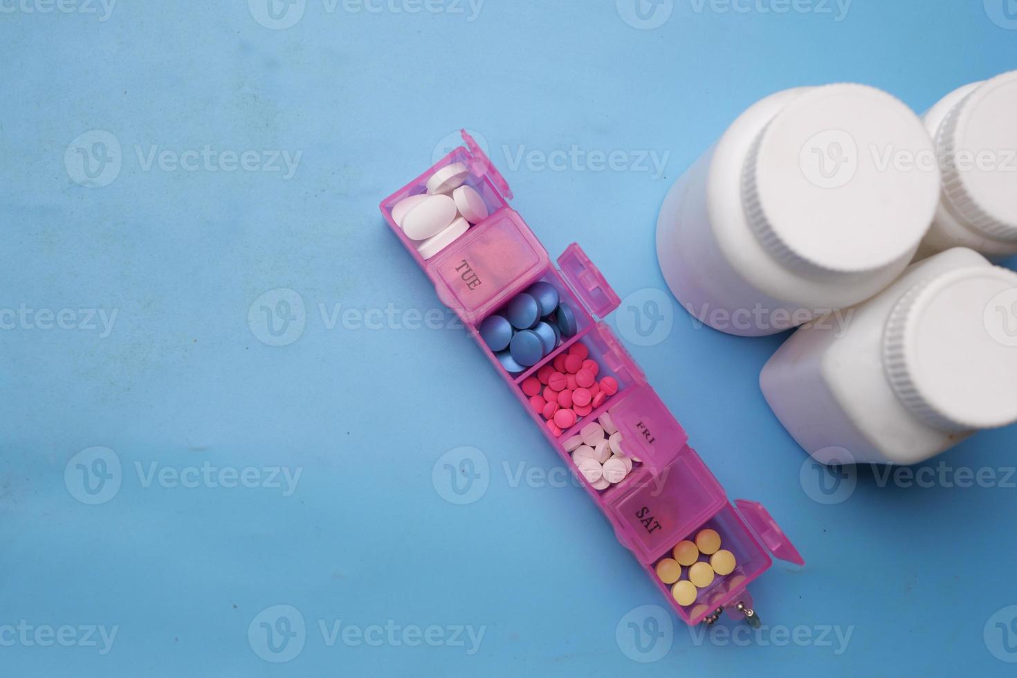 close up of medical pills in a pill box on table photo