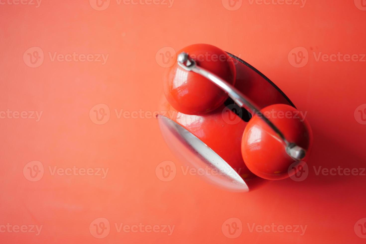 red color old alarm clock on table photo