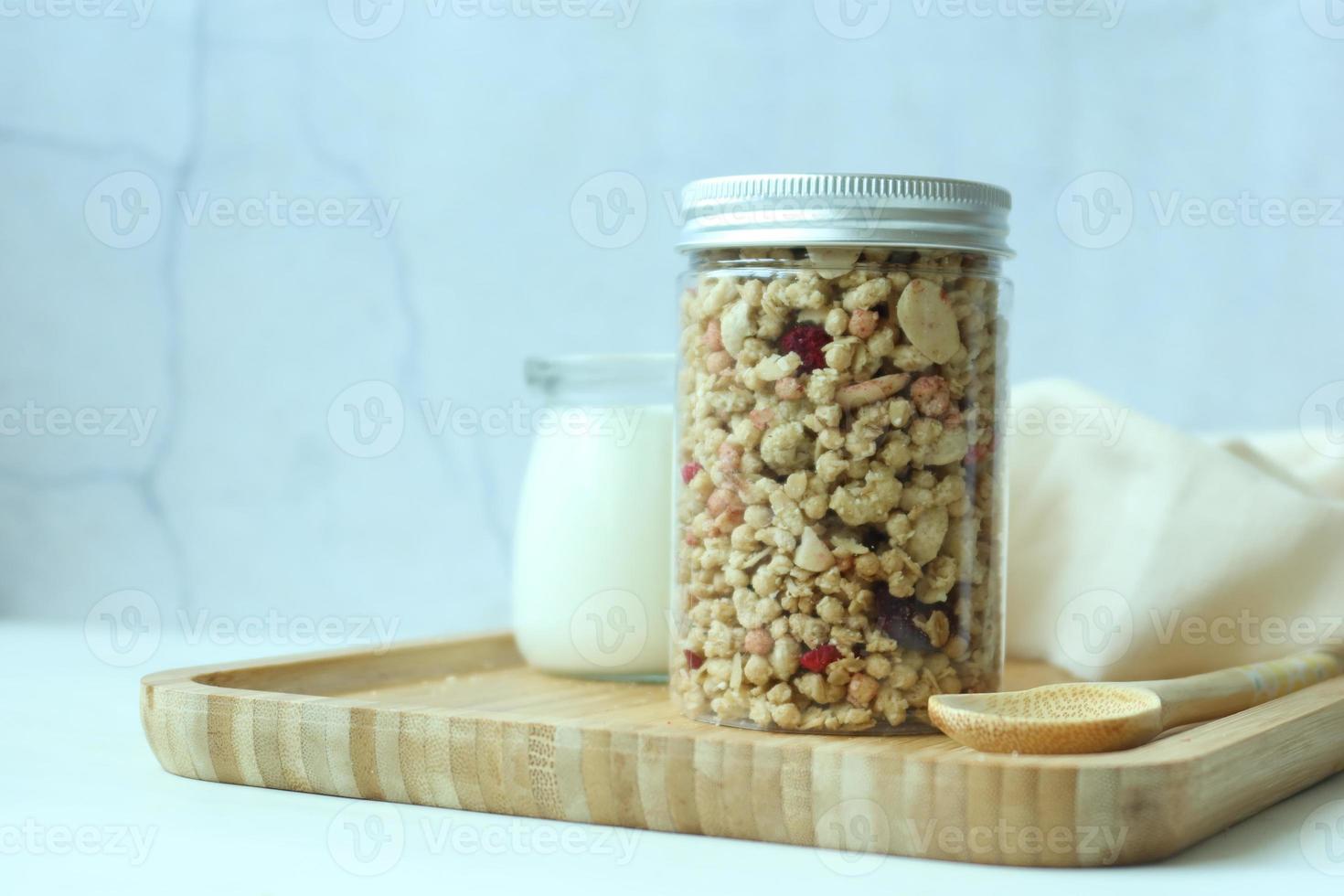 granola Musli and glass of milk on table photo