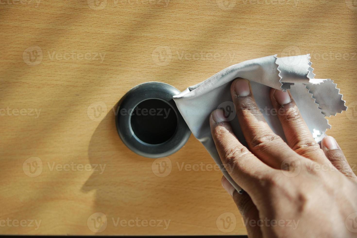 person hand cleaning a drawer with cloth photo