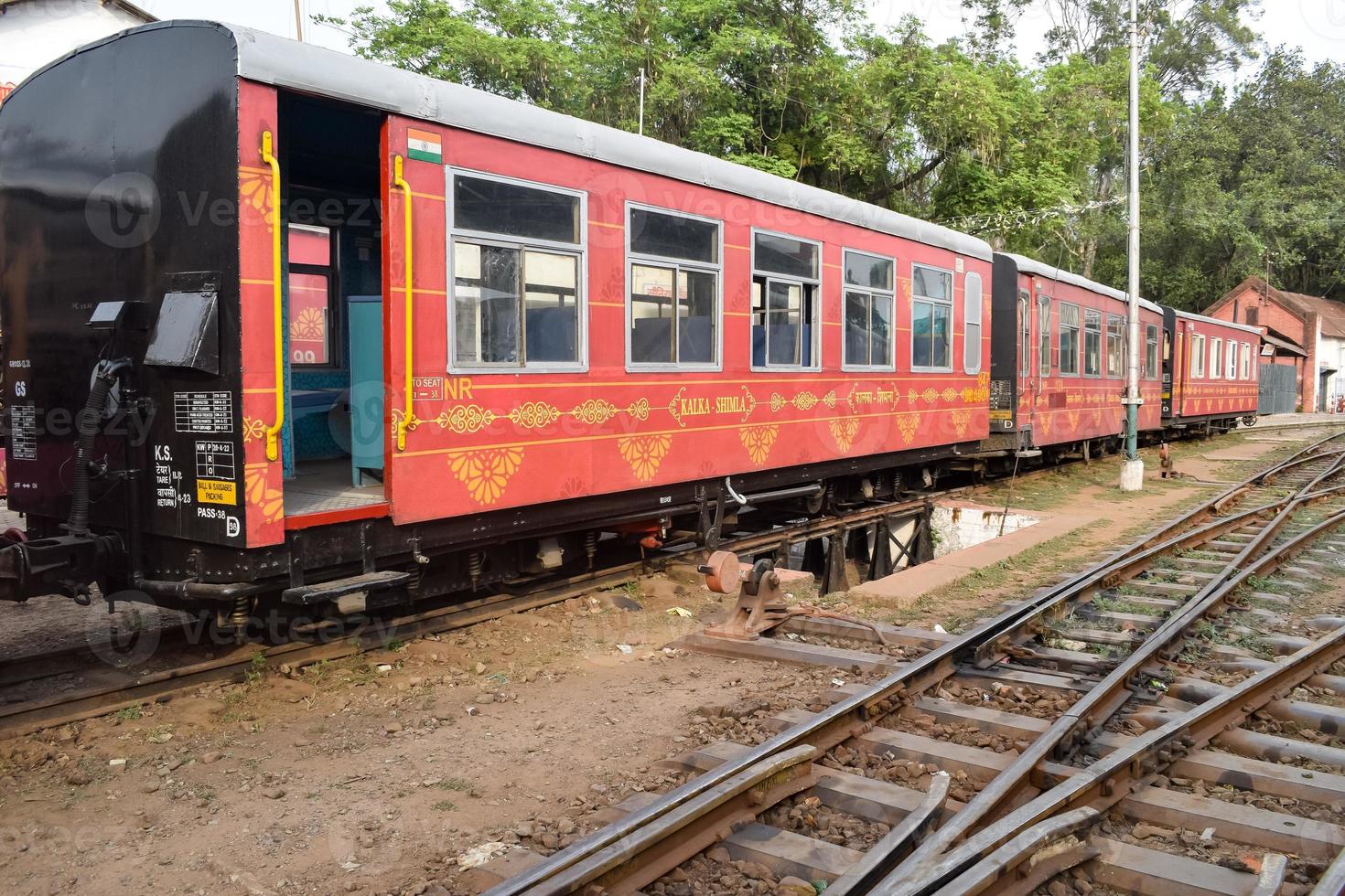 View of Toy train coach from the middle of railway track during daytime near Kalka railway station in India, Toy train coach view, Indian Railway junction, Heavy industry photo