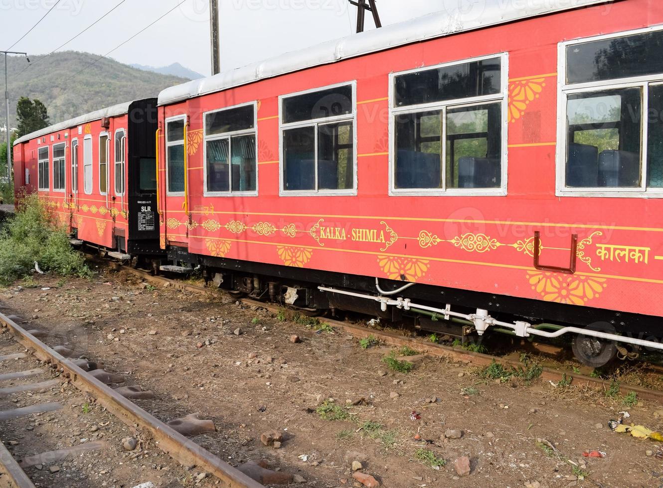 View of Toy train coach from the middle of railway track during daytime near Kalka railway station in India, Toy train coach view, Indian Railway junction, Heavy industry photo