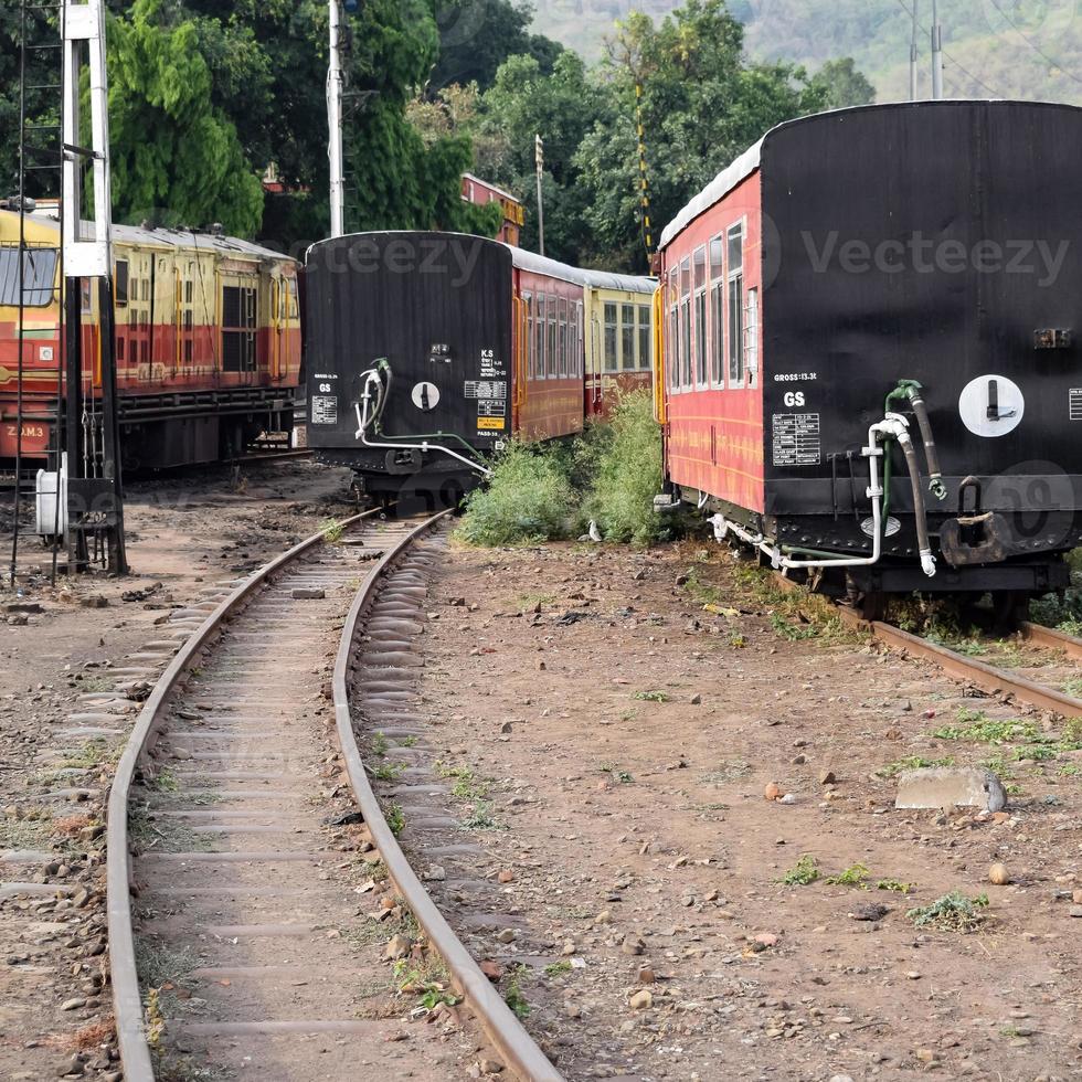 View of Toy train coach from the middle of railway track during daytime near Kalka railway station in India, Toy train coach view, Indian Railway junction, Heavy industry photo
