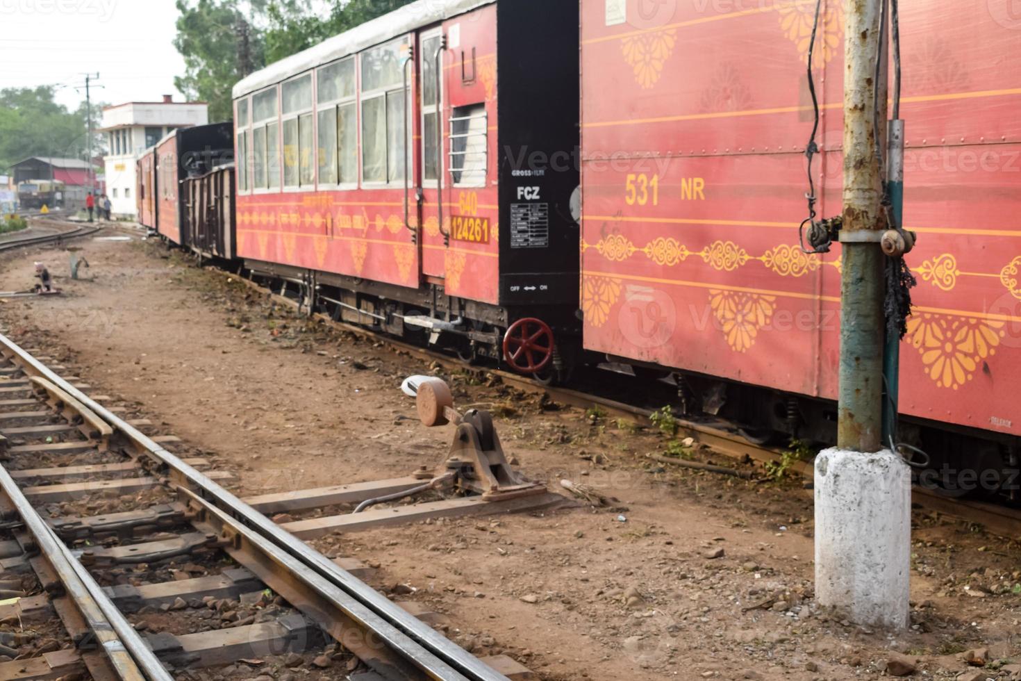 View of Toy train coach from the middle of railway track during daytime near Kalka railway station in India, Toy train coach view, Indian Railway junction, Heavy industry photo