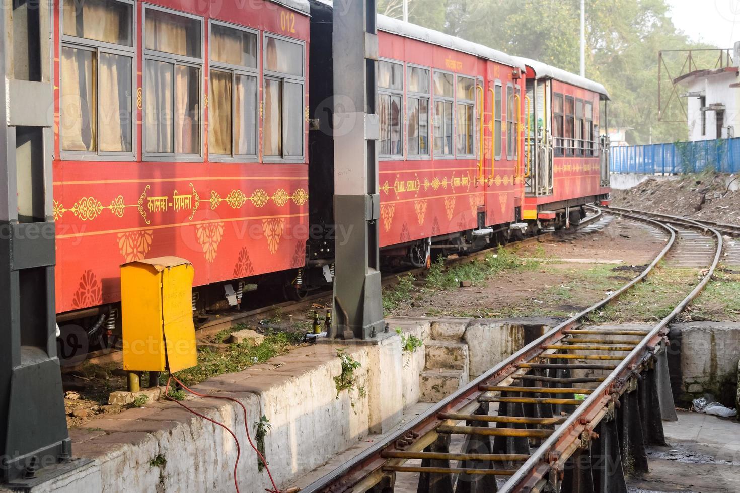 vista del vagón de tren de juguete desde el medio de la vía férrea durante el día cerca de la estación de tren de kalka en india, vista del vagón de tren de juguete, unión ferroviaria india, industria pesada foto