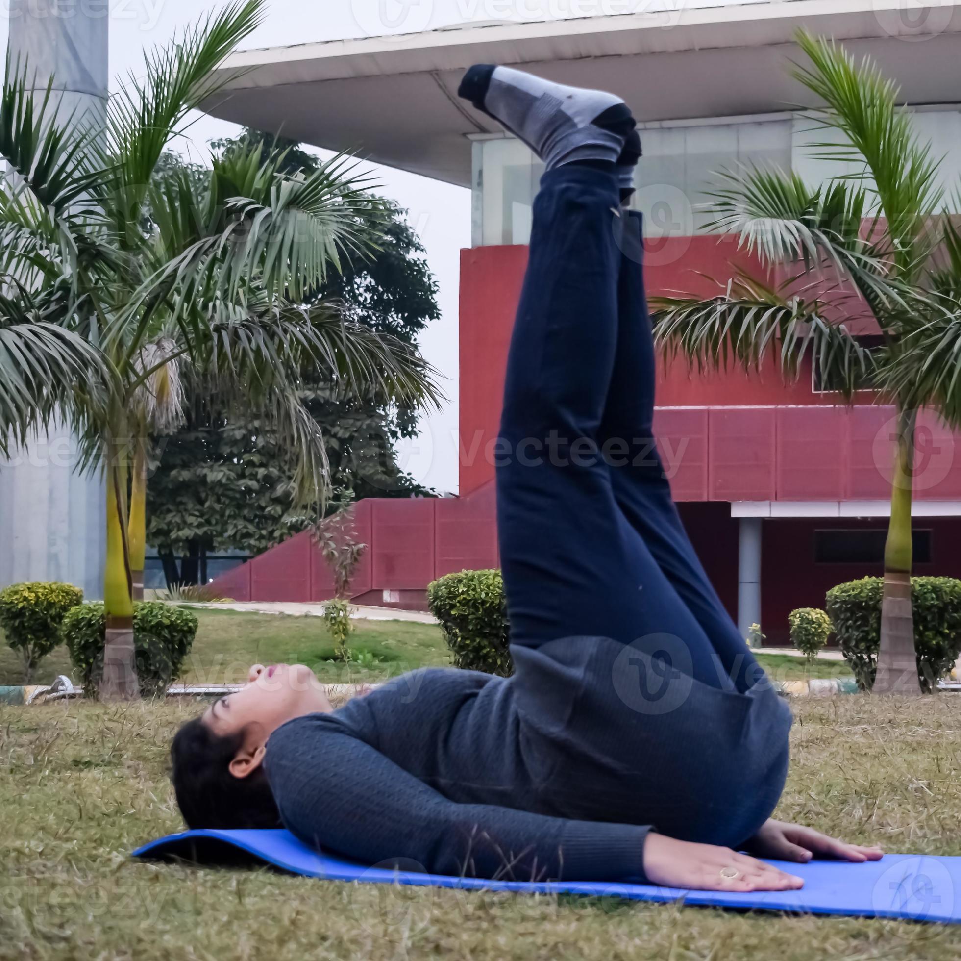 Young beautiful female doing yoga tree pose