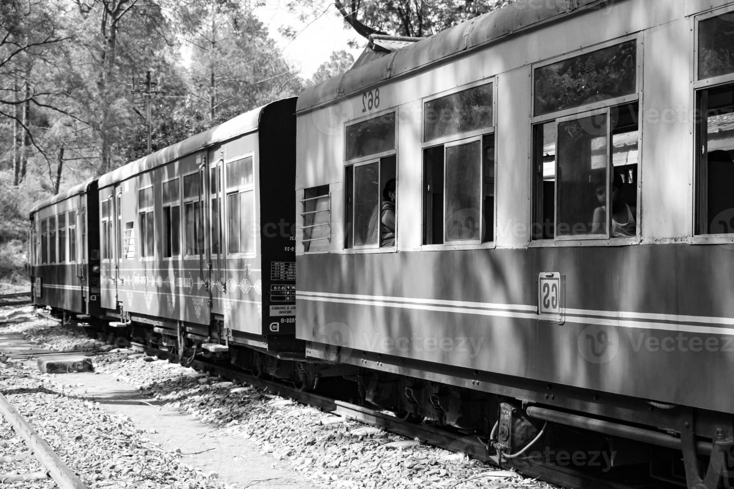 Toy Train moving on mountain slope, beautiful view, one side mountain, one side valley moving on railway to the hill, among green natural forest. Toy train from Kalka to Shimla in India photo