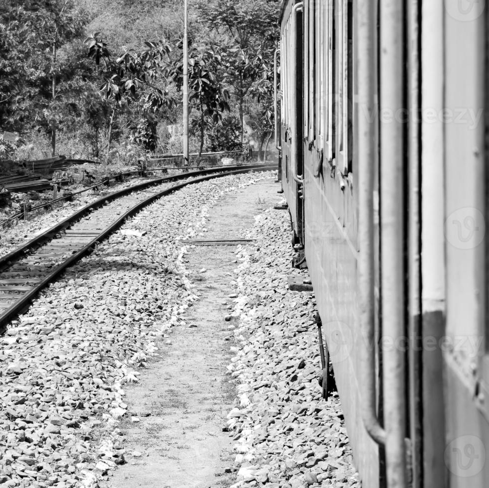 Toy Train moving on mountain slope, beautiful view, one side mountain, one side valley moving on railway to the hill, among green natural forest. Toy train from Kalka to Shimla in India photo