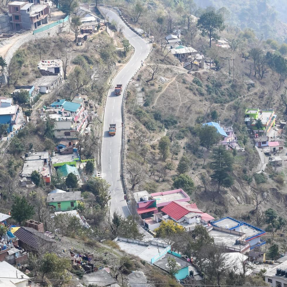 Aerial top view of traffic vehicles driving at mountains roads at Nainital, Uttarakhand, India, View from the top side of mountain for movement of traffic vehicles photo