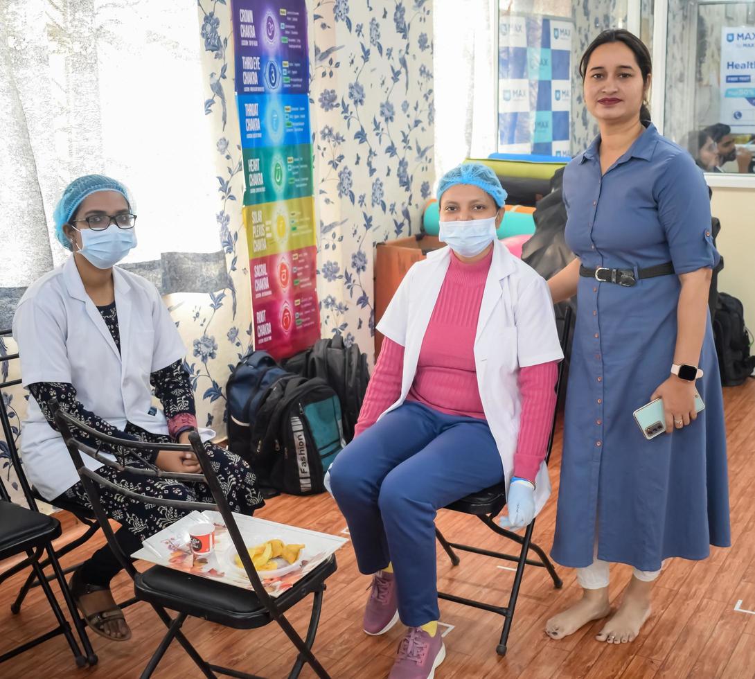 Delhi, India - November 19, 2022 - Basic routine health check-up camp has been organized by max hospital specialized doctors, Patient at annual health check-up, Doctor doing health check-up to patient photo