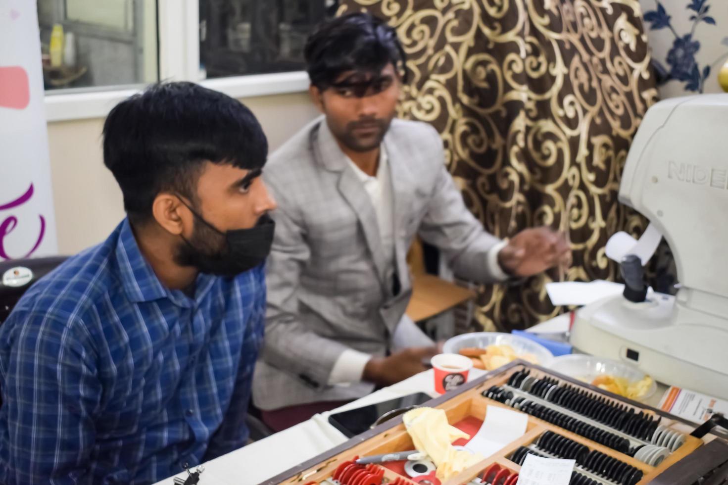 Delhi, India - November 19, 2022 - Basic routine health check-up camp has been organized by max hospital specialized doctors, Patient at annual health check-up, Doctor doing health check-up to patient photo