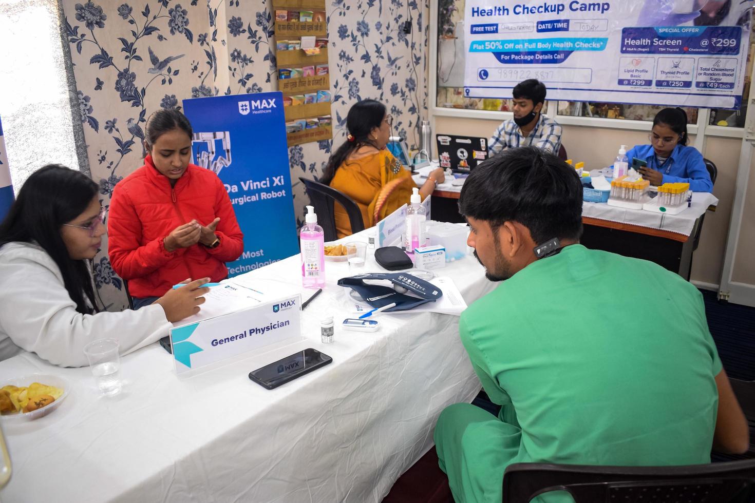 Delhi, India - November 19, 2022 - Basic routine health check-up camp has been organized by max hospital specialized doctors, Patient at annual health check-up, Doctor doing health check-up to patient photo