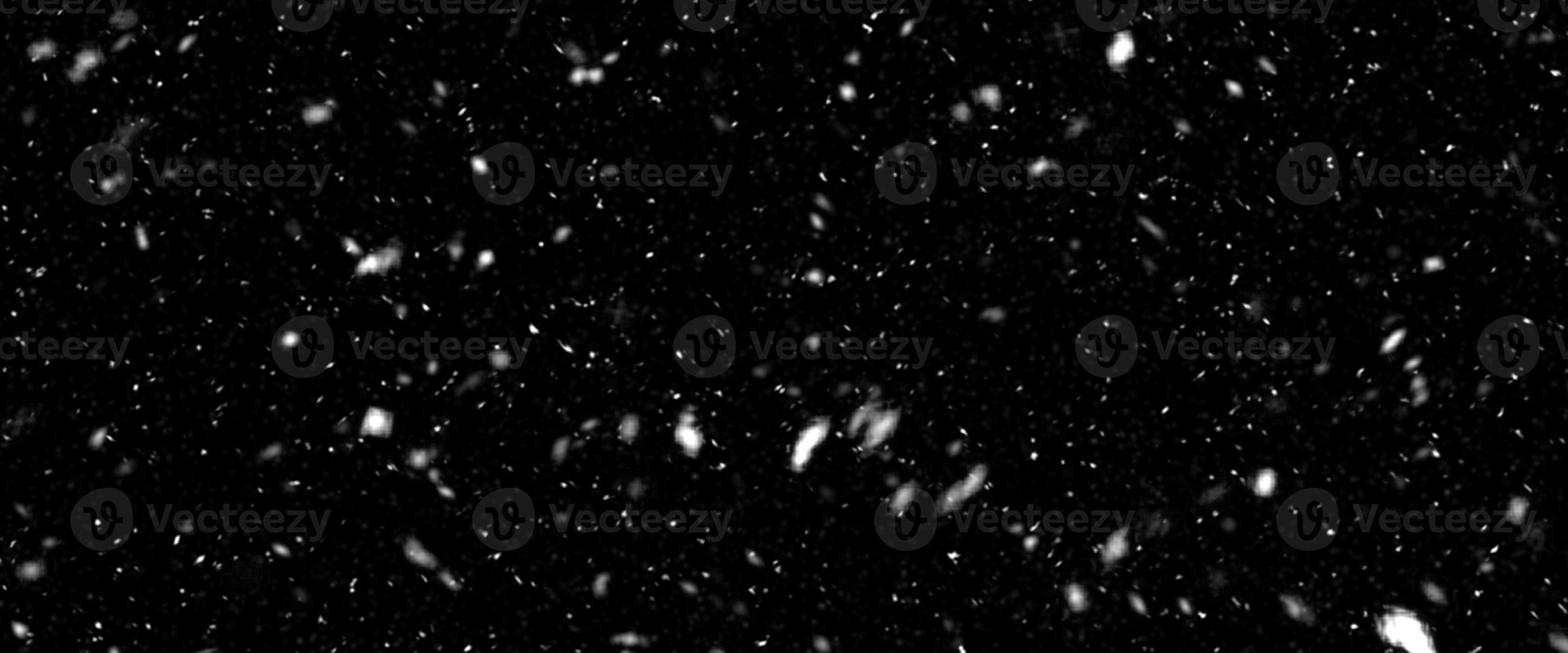 Different realistic falling snow or snowflakes. Falling snow isolated on black background. Winter snowfall illustration. Bokeh lights on black background, flying snowflakes in the air. Snow at night. photo