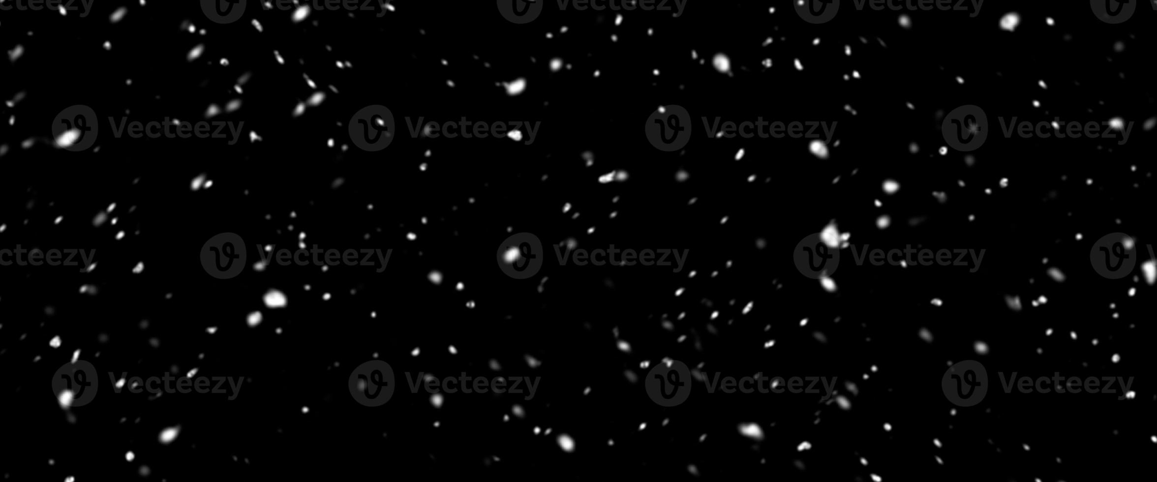 Falling snow isolated on black background. Falling snow at night. Bokeh lights on black background, flying snowflakes in the air. Winter weather. Overlay texture. photo