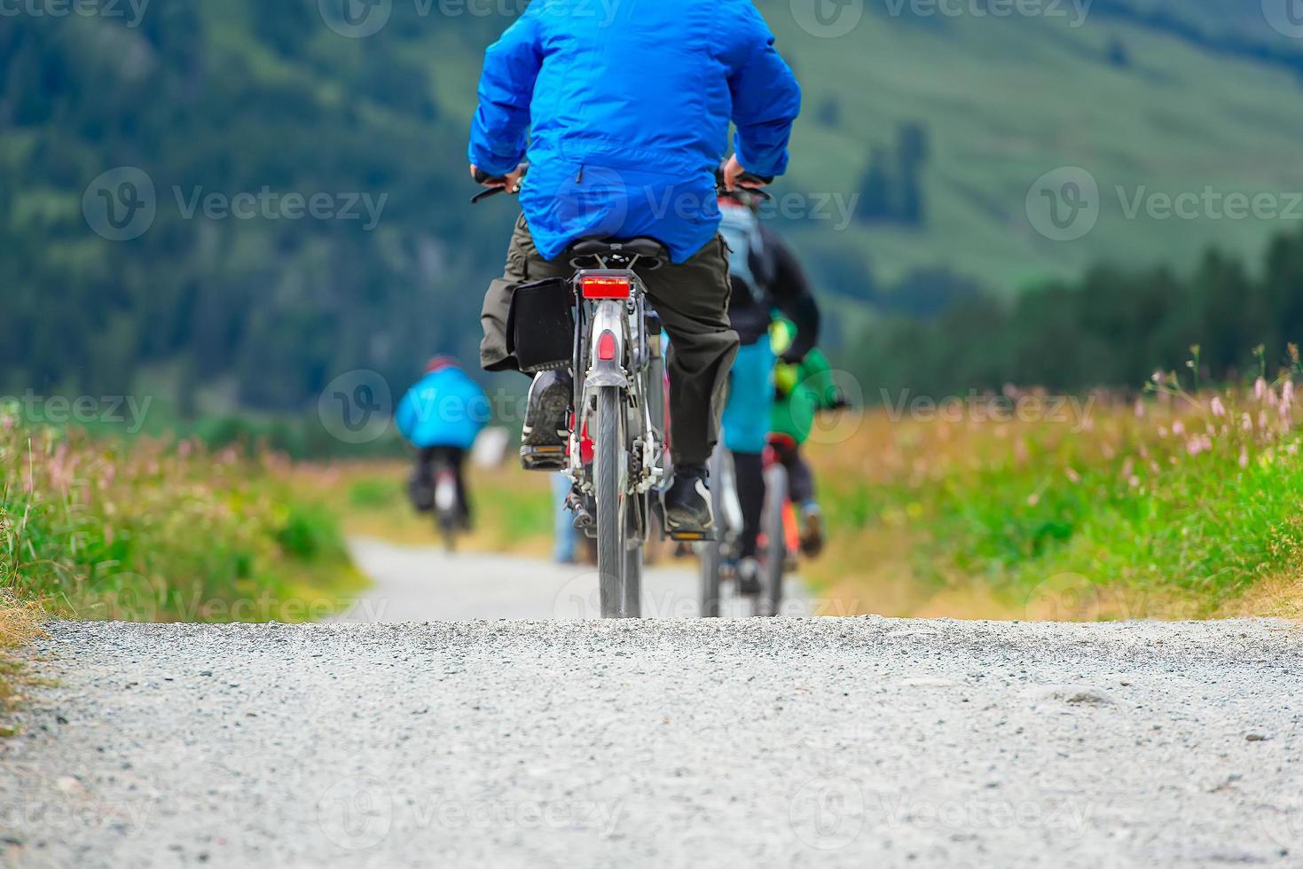 Cycling in dirt track in mountain meadows photo