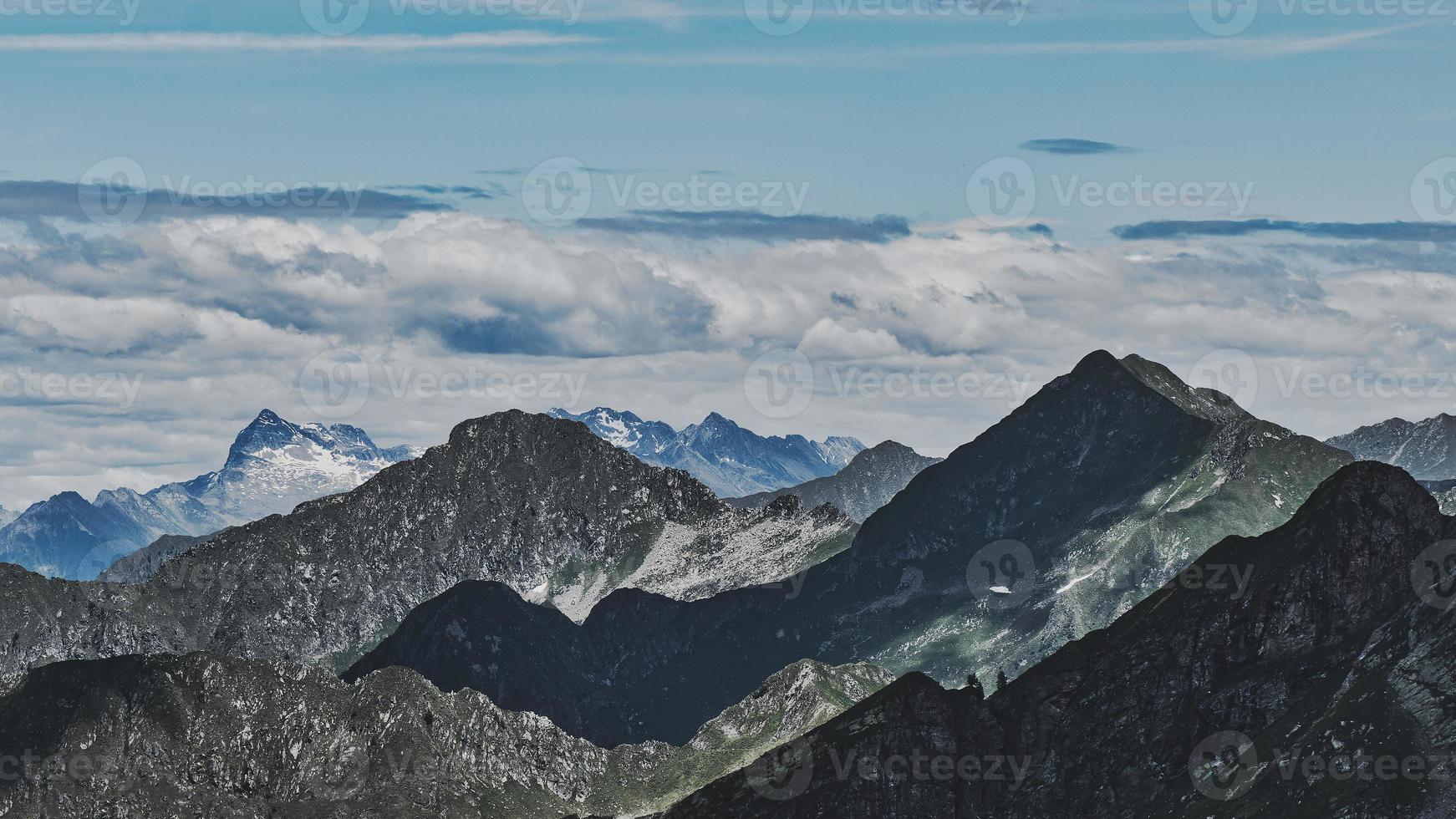 Panorama of mountain range with games of shadows and lights photo