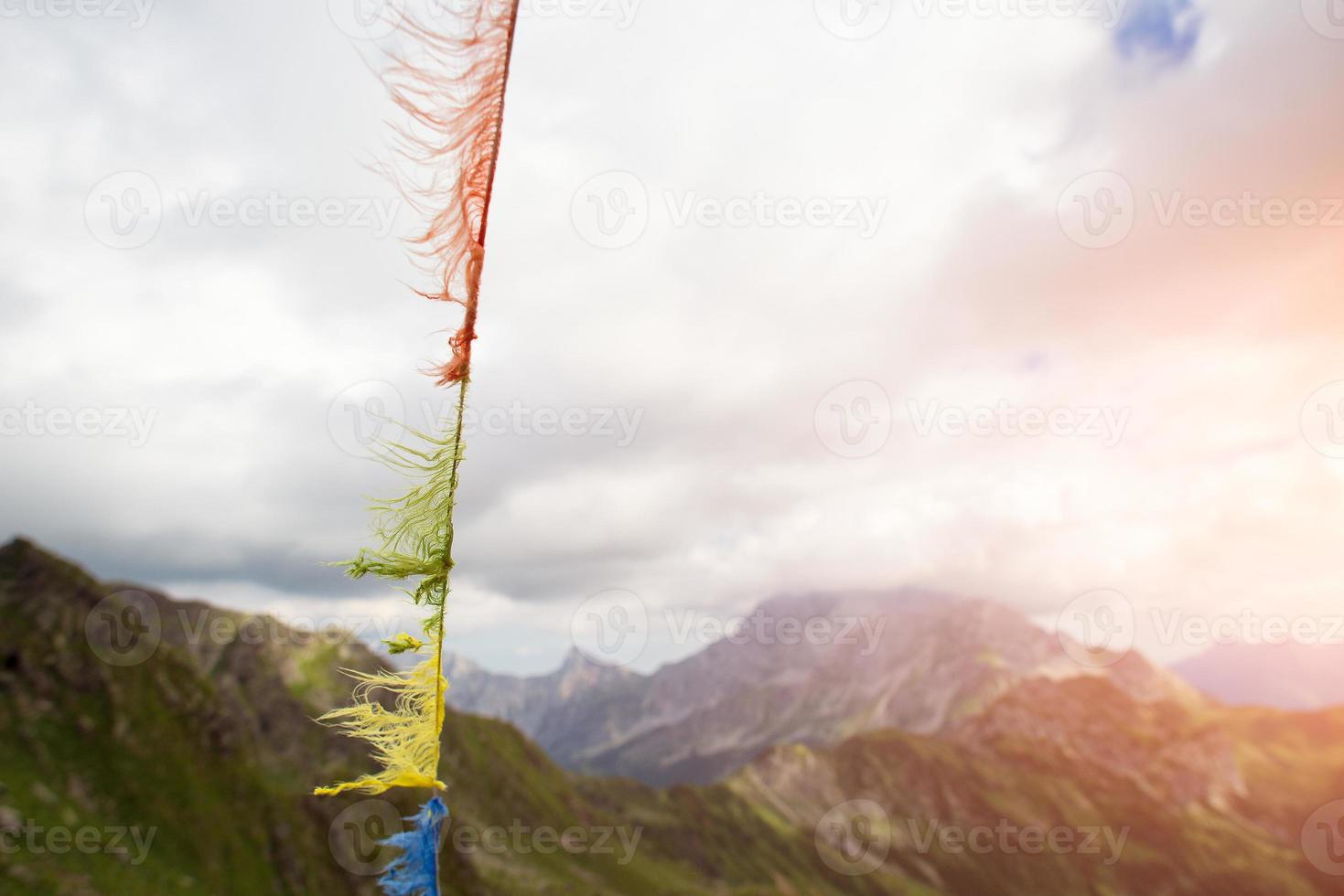 Tibetan prayer flags ruined by the wind photo