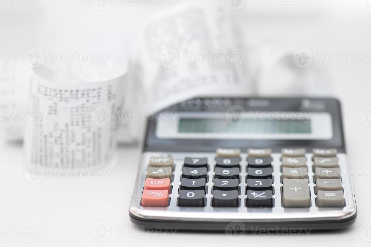 Calculator with many receipts for calculating family budgets photo