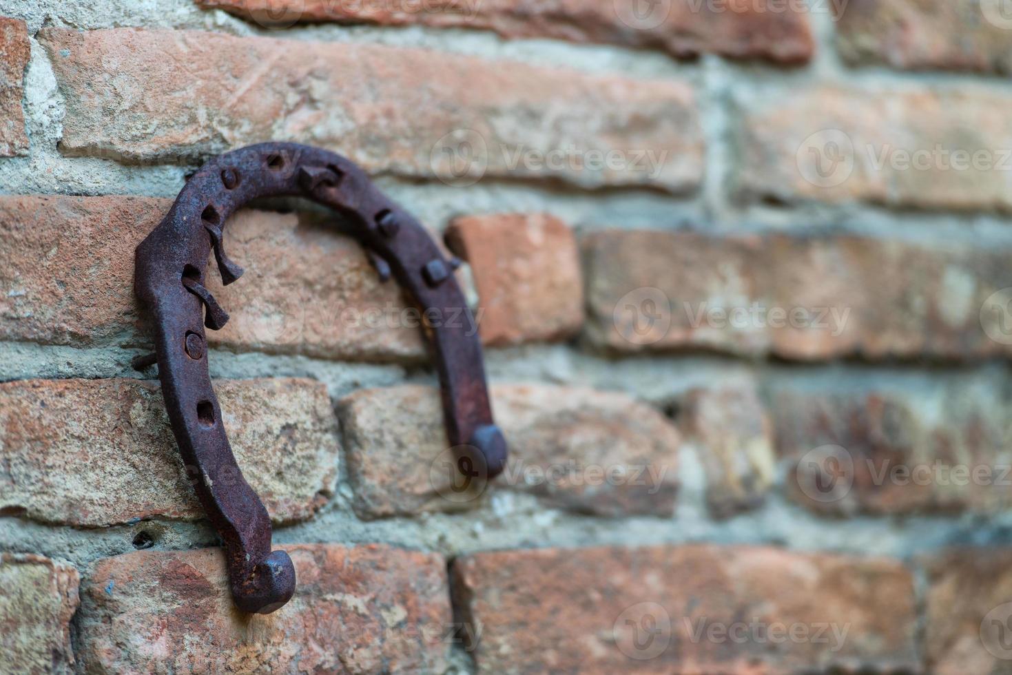 Horseshoe hanging on an old wall photo