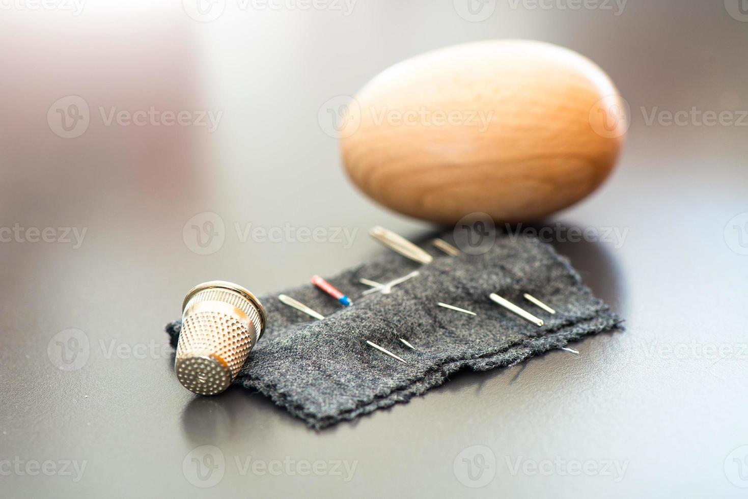 Sewing needles with thimble and egg for mitt photo