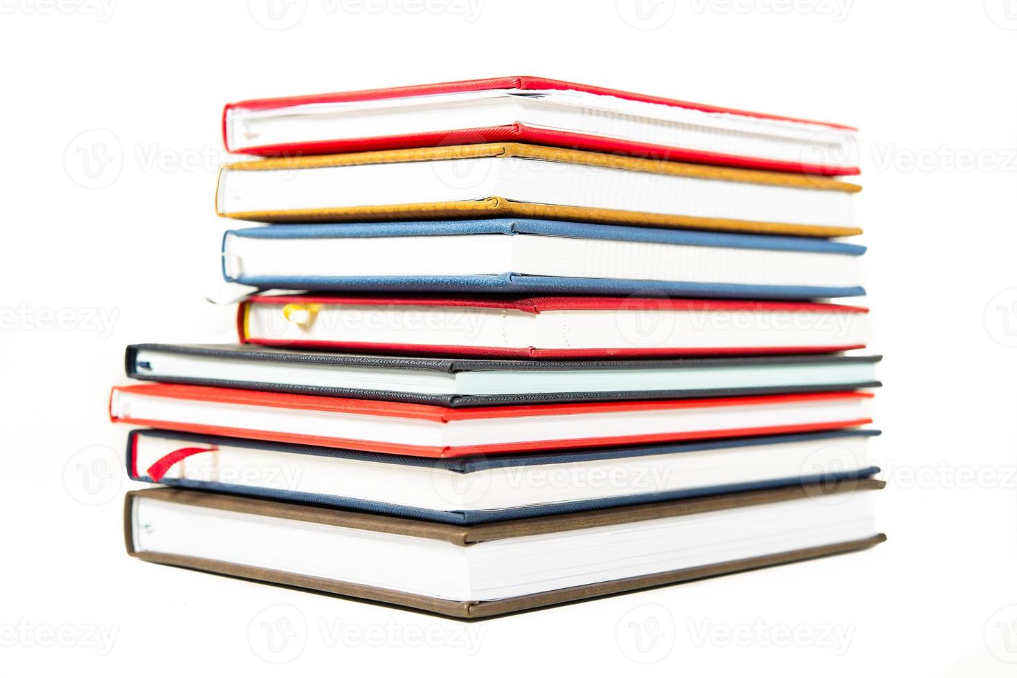 Stack of diaries on white background photo