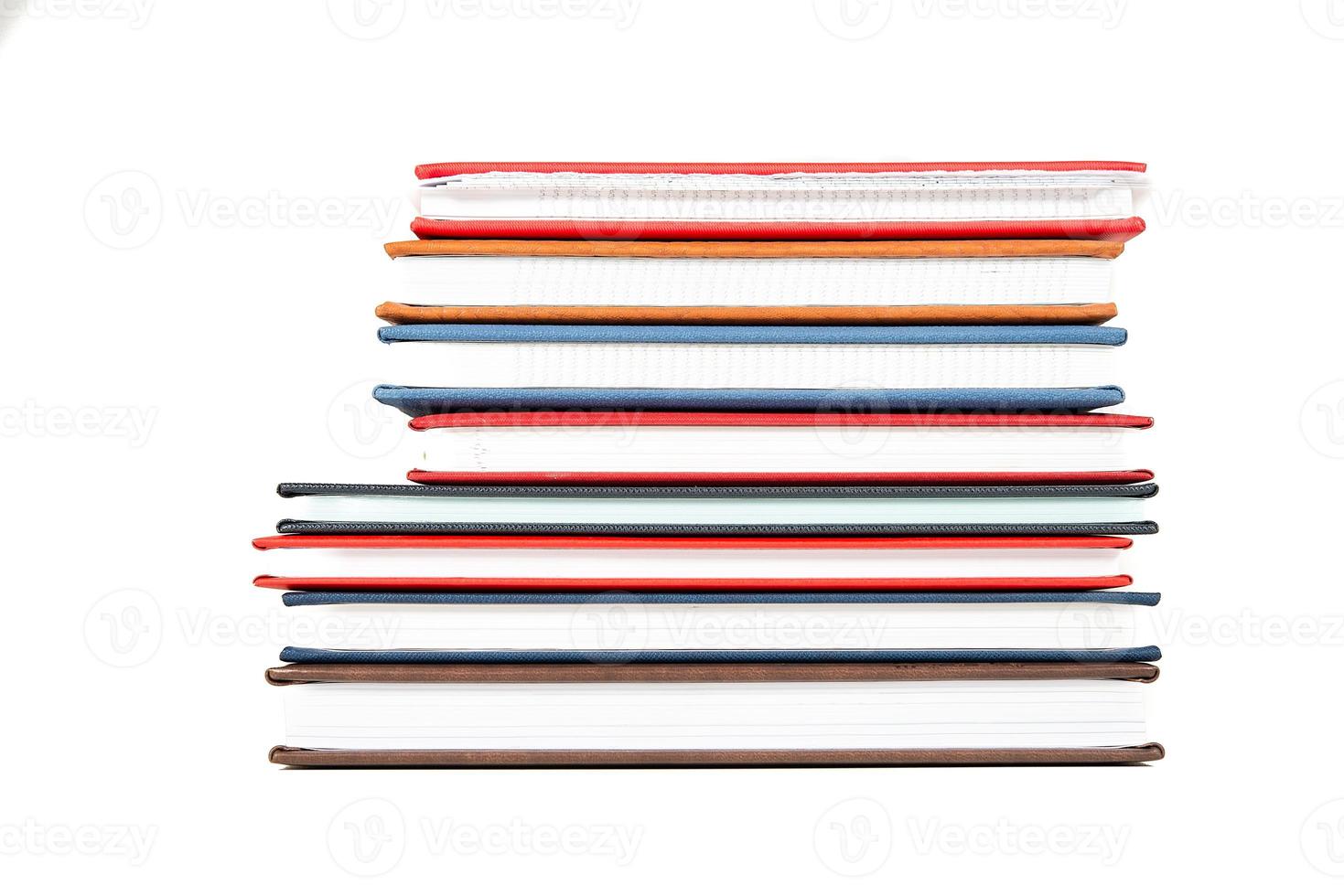Stack of diaries on white background photo