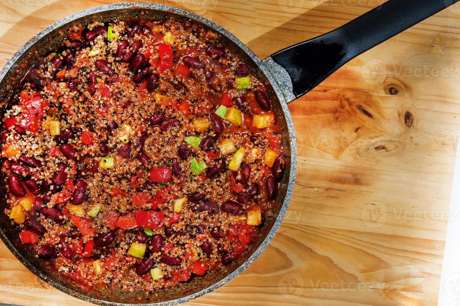 Chili Beans on white table, top view, copy space. Homemade stewed vegan vegetarian recipe with kidney beans and vegetables. photo
