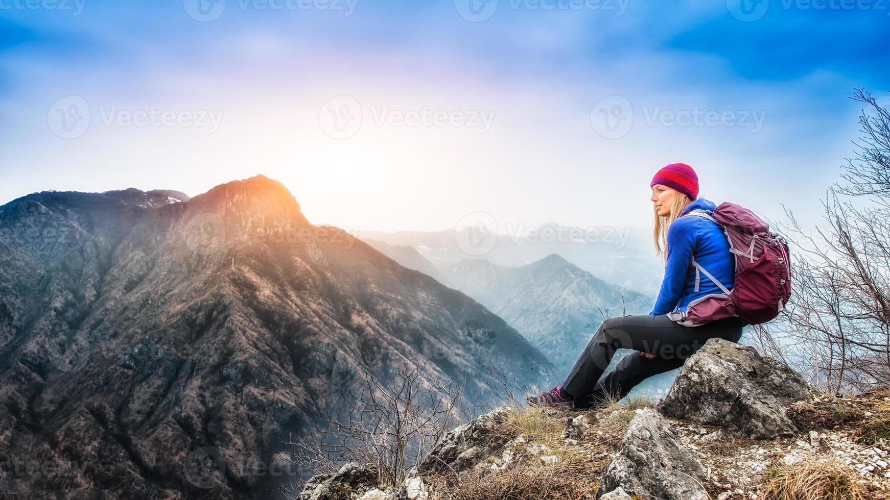 Girl resting on top of the mountain after a trek photo