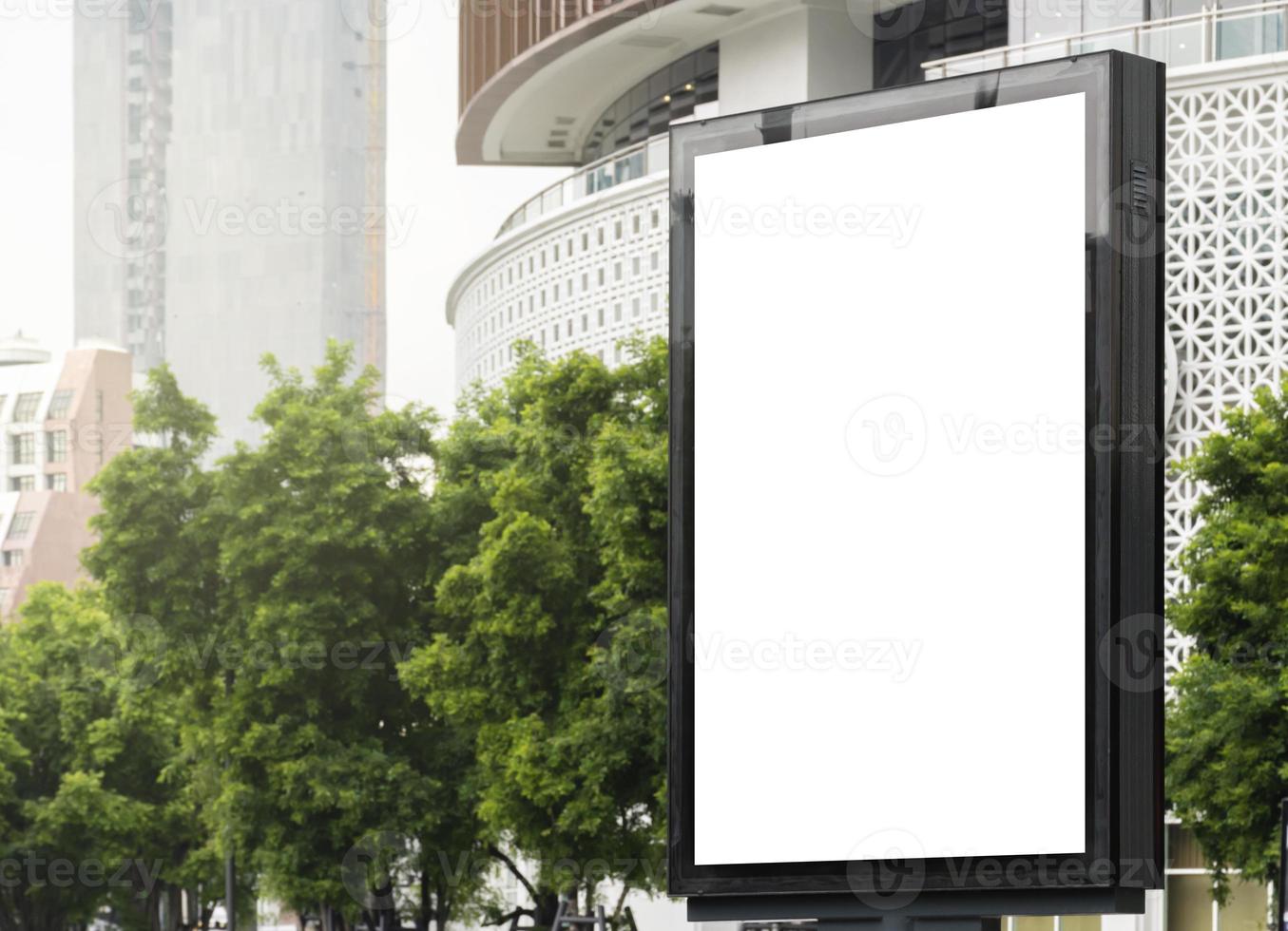 Outdoor pole billboard with mock up white screen on city view background and clipping path photo