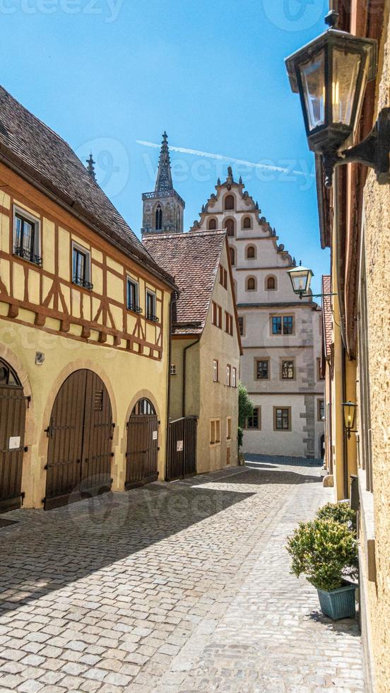 City scene of Rotenburg ob der Tauber in Bavaria with old frame houses and cobblestone pavement in summer photo