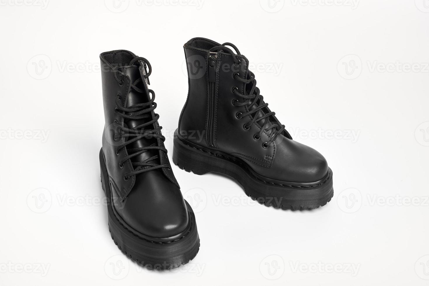 Black women combat boots on high heel platform with lug soles on isolated white background photo