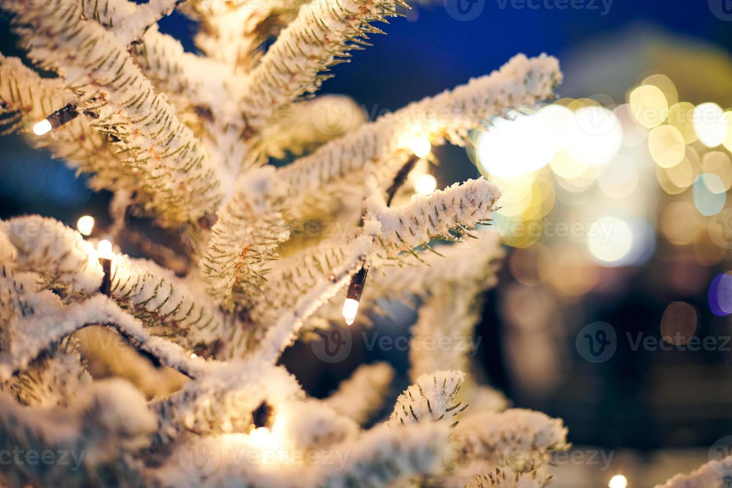 Christmas tree with yellow garlands lights and bokeh copy space with sparkled bokeh, Christmas time photo