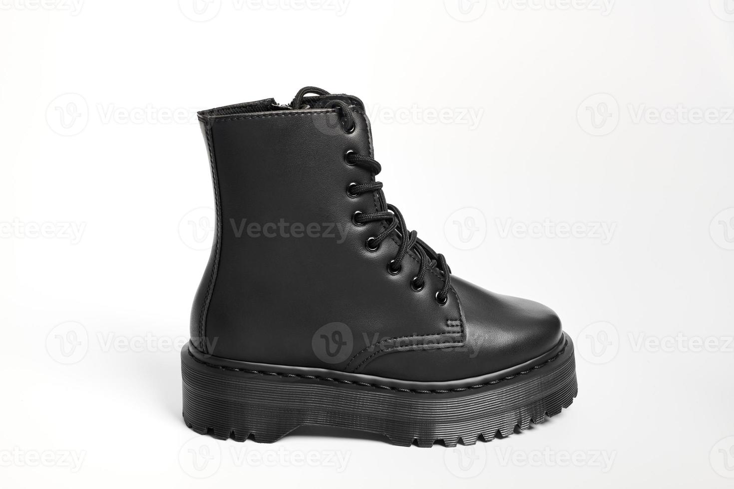 One black women combat boot on high heel platform with lug sole on isolated white background photo