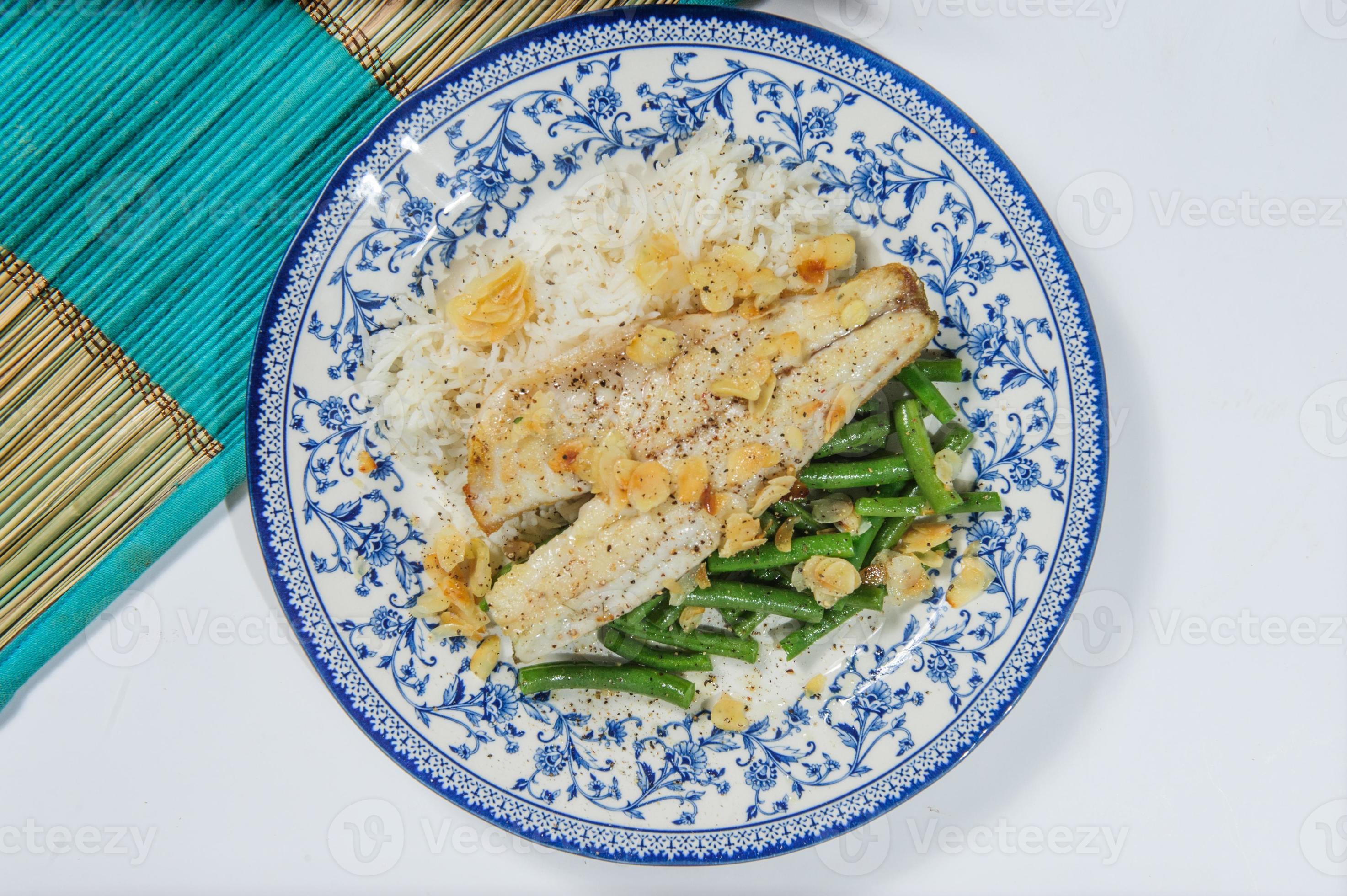 Lebanesestyle fried fish on a serving dish with onion flavoured rice