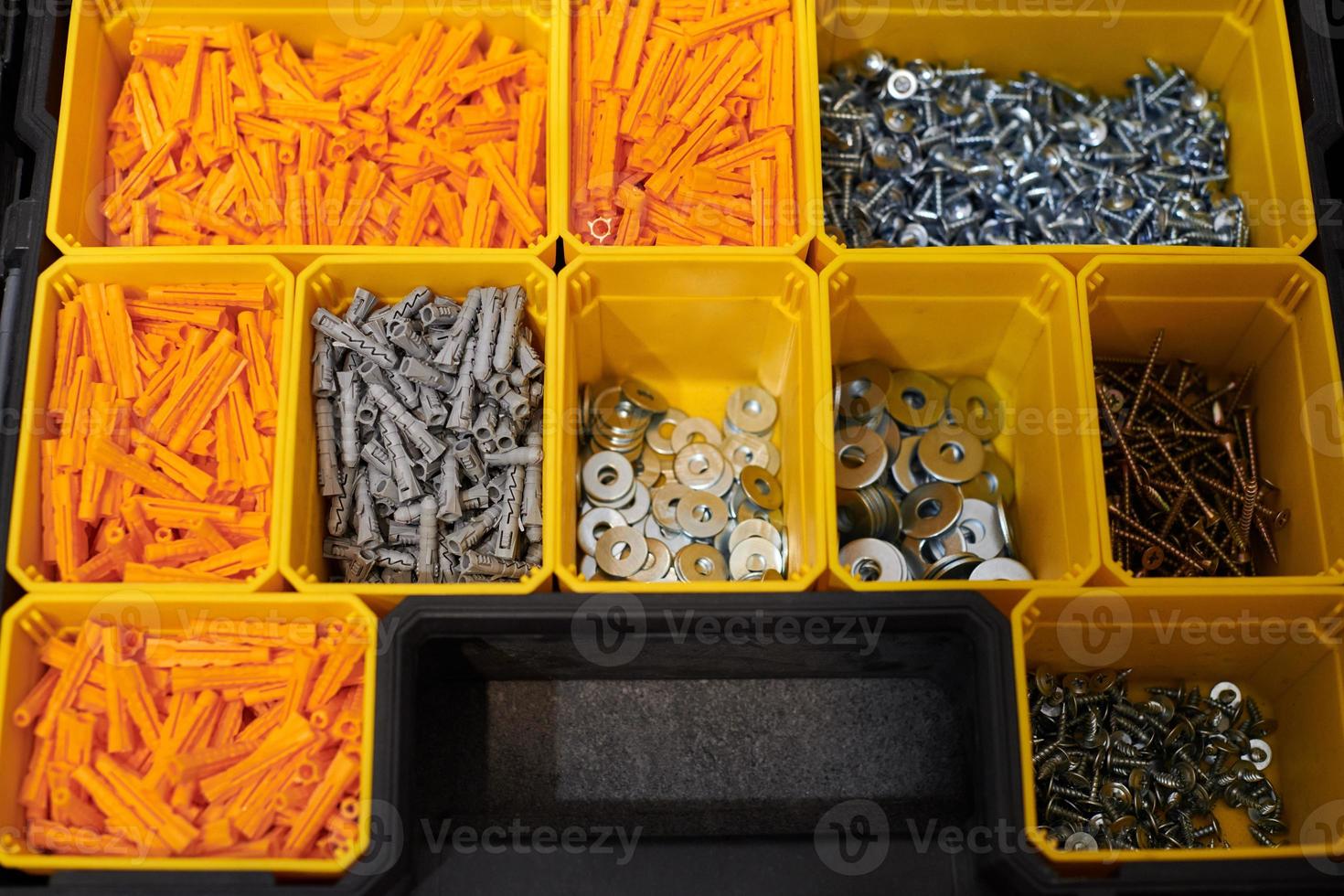 Storage case with screws, nuts, bolts, nails and other small tools for repairer, top view photo