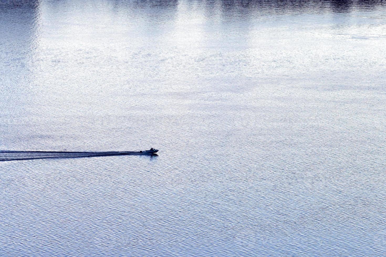 Little boat sailing on river photo
