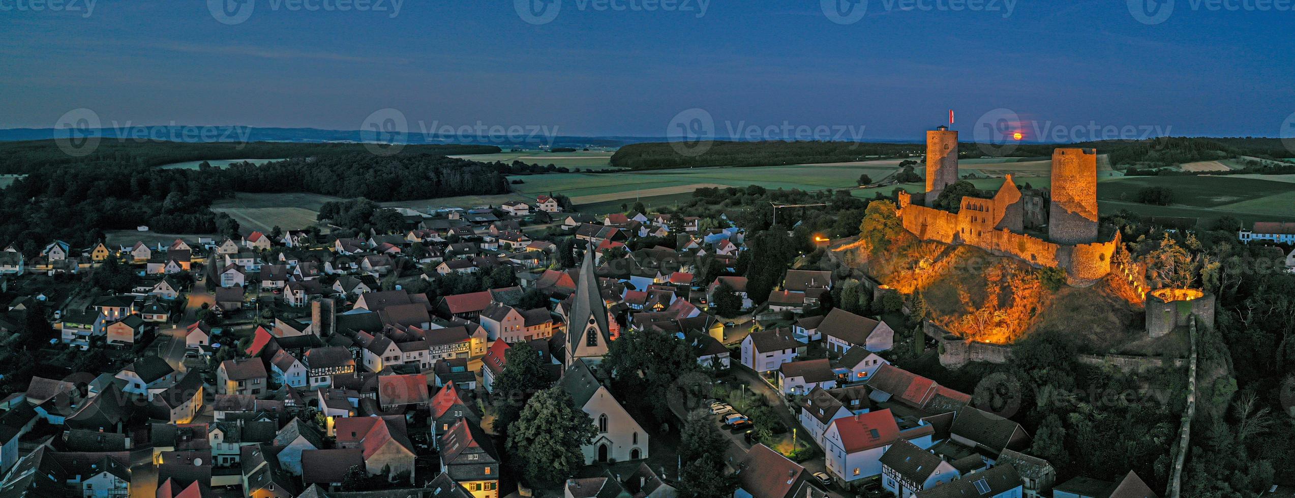 Image of illuminated Muenzenberg castle ruin in Germany in the evening photo