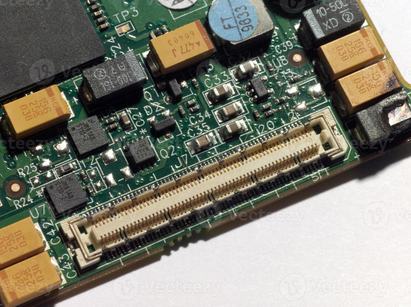 A computer circuit board with fire damage photo