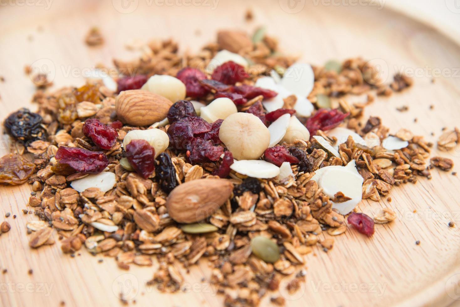 Closed up and blur breakfast healthy food, granola, musli, Organic oat, super food with honey, dried fruits and nuts on wooden plate photo