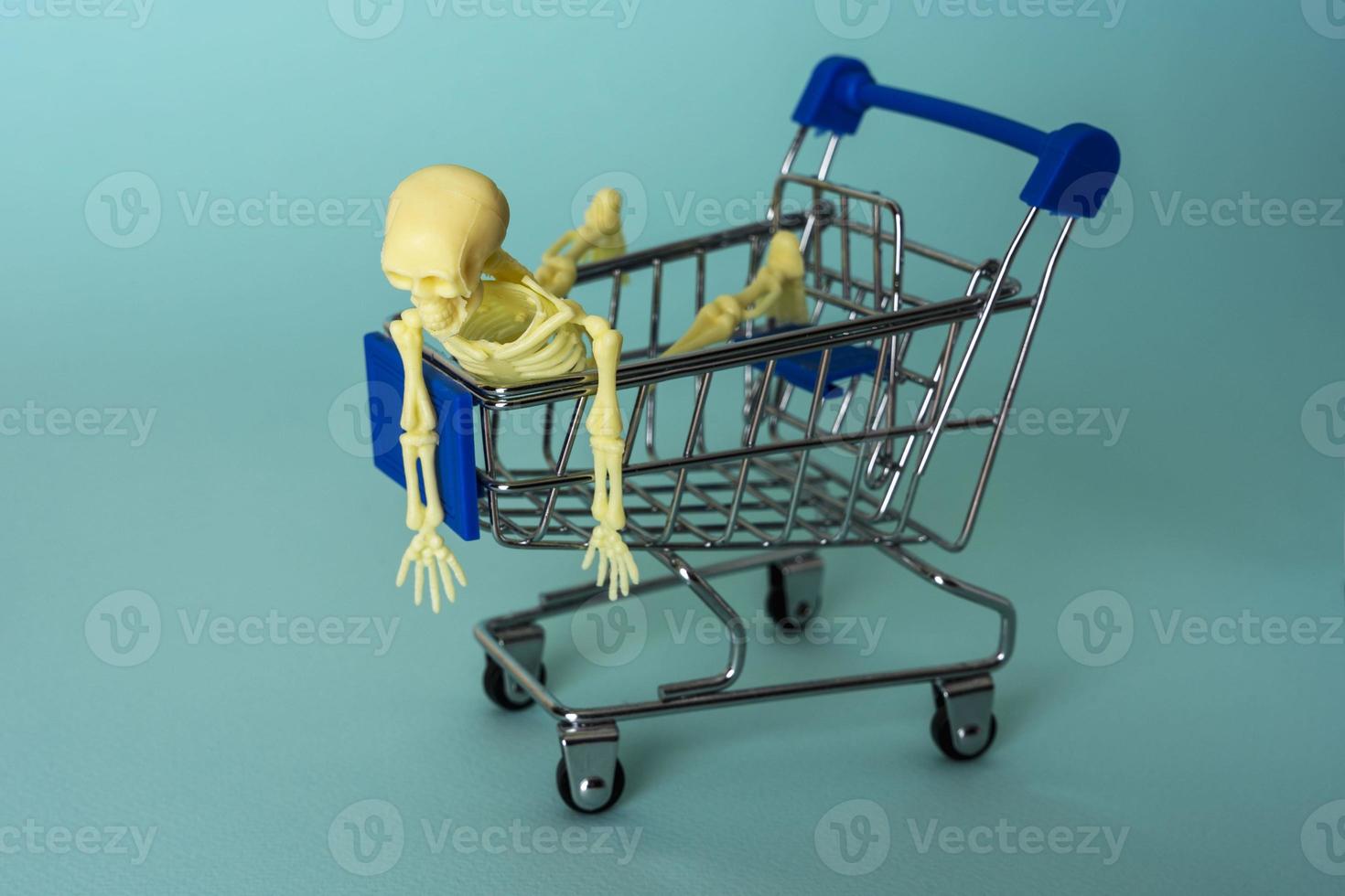 creative minimalist composition, a skeleton riding on a supermarket cart, turquoise background, a skull photo