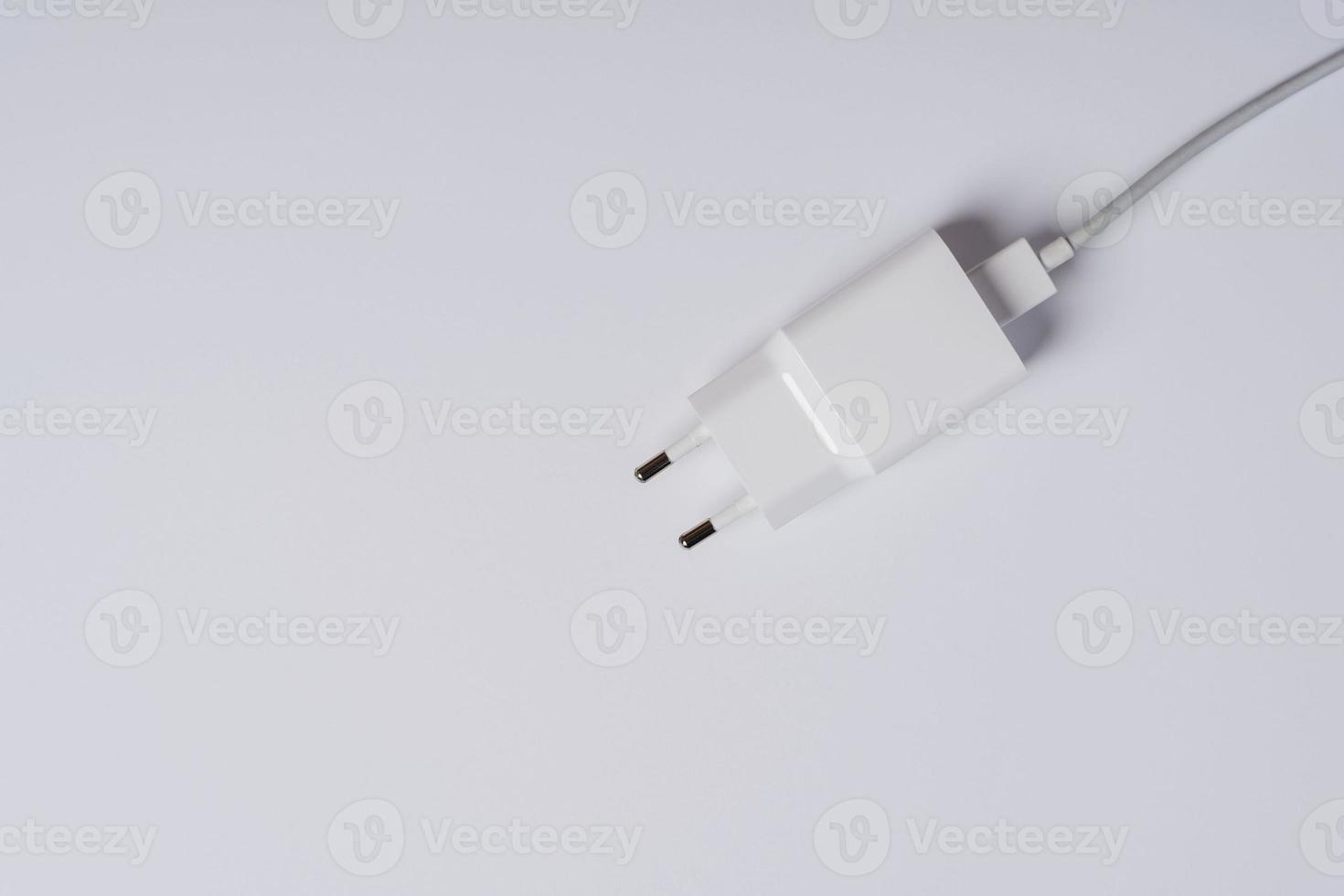 White phone charger close-up on a white background, copying space photo