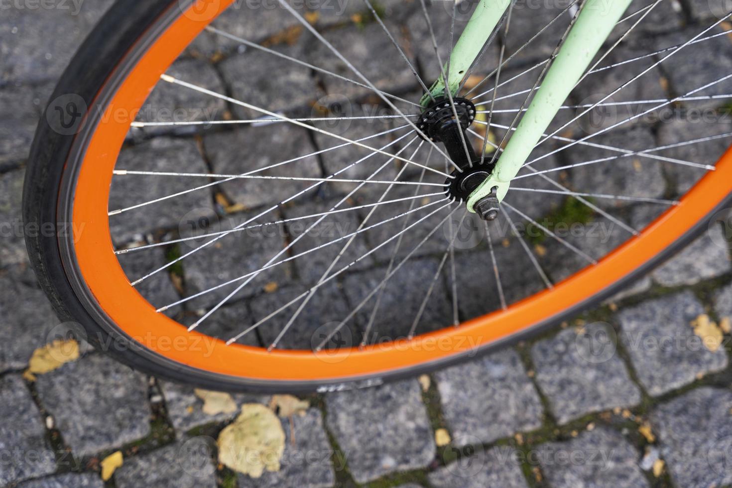 A city bike parked against the wall of a cafe in the city, Cycling to work, a stylish bike in an urban environment photo