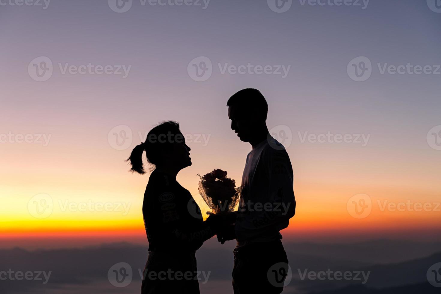 Silhouette of wedding Couple in love during sunrise with morning sky background. Pre-wedding portraits happy couple images man and woman with sky nature background. valentines day concept. photo